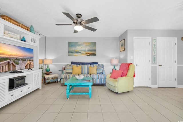 living room featuring a ceiling fan and light tile patterned flooring