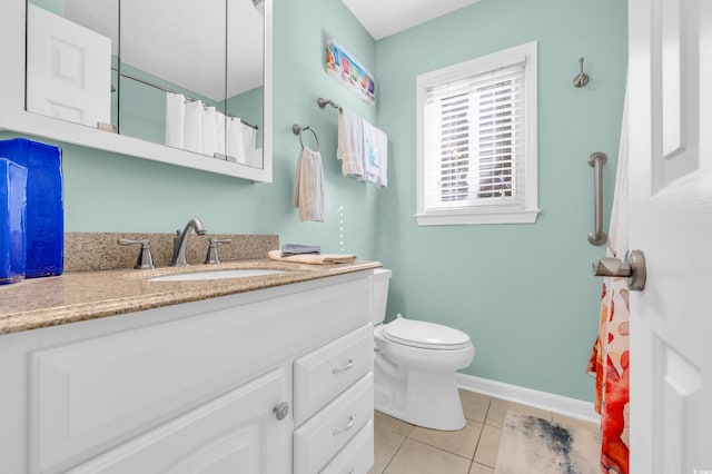 bathroom featuring toilet, vanity, baseboards, and tile patterned floors