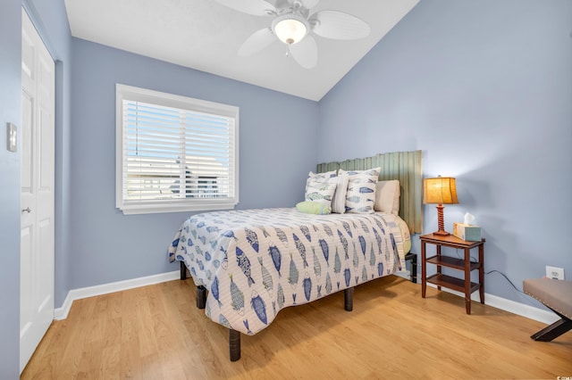 bedroom featuring ceiling fan, vaulted ceiling, baseboards, and wood finished floors