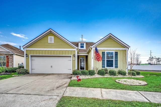 view of front of home featuring a garage, a shingled roof, driveway, a front lawn, and board and batten siding