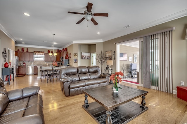 living area with ceiling fan, recessed lighting, visible vents, light wood-style floors, and ornamental molding