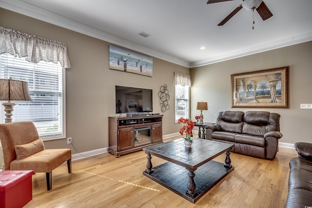 living area with light wood-style floors, visible vents, ornamental molding, and baseboards