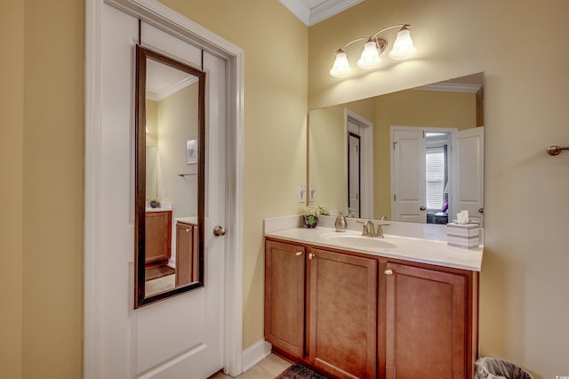 bathroom with crown molding, vanity, and tile patterned floors