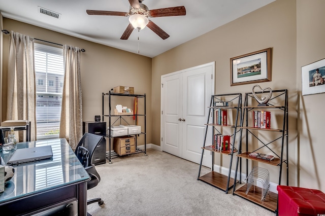 home office with baseboards, carpet flooring, visible vents, and a ceiling fan