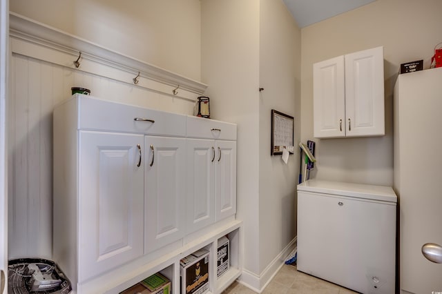 mudroom with light tile patterned floors and baseboards