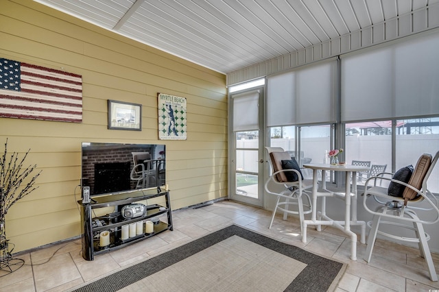 sunroom / solarium featuring wood ceiling