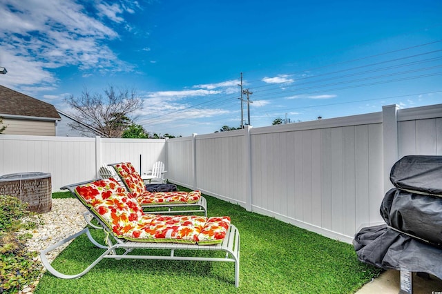 view of yard featuring fence and central air condition unit