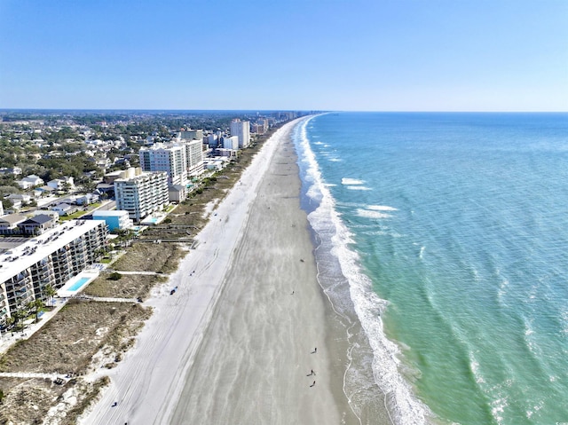 bird's eye view featuring a view of city, a water view, and a beach view