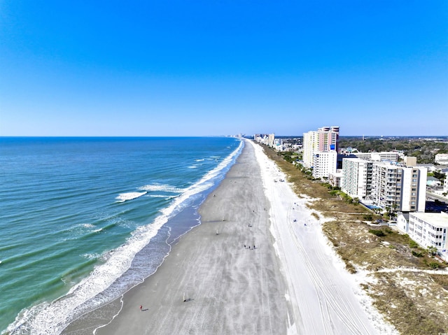 birds eye view of property featuring a city view, a water view, and a beach view