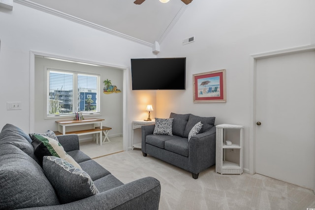 carpeted living area with visible vents, a ceiling fan, crown molding, and vaulted ceiling