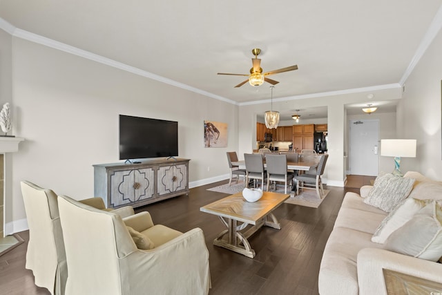 living room with a ceiling fan, crown molding, dark wood-style floors, and baseboards