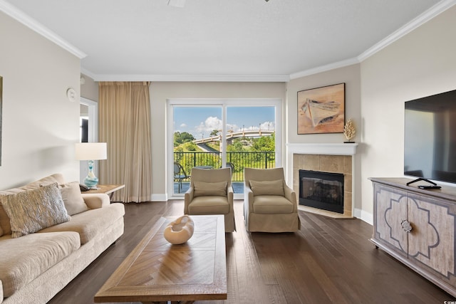 living area with ornamental molding, a fireplace, dark wood-style floors, and baseboards