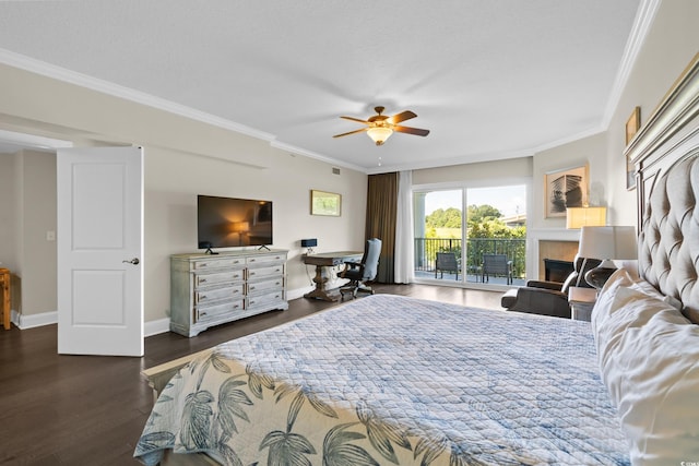 bedroom featuring access to outside, wood finished floors, crown molding, a tiled fireplace, and ceiling fan
