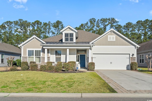 craftsman-style home with concrete driveway, metal roof, an attached garage, a standing seam roof, and a front lawn