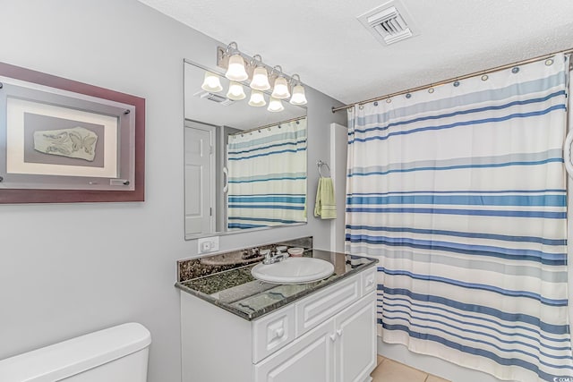 full bathroom with toilet, visible vents, a textured ceiling, and vanity