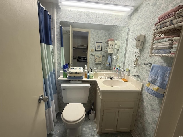 bathroom featuring tile patterned floors, vanity, toilet, and wallpapered walls