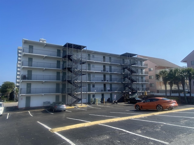 view of building exterior featuring uncovered parking