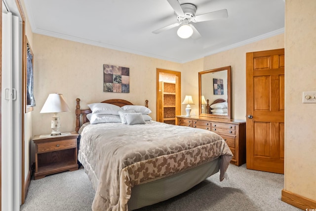 bedroom featuring crown molding, a ceiling fan, and light colored carpet