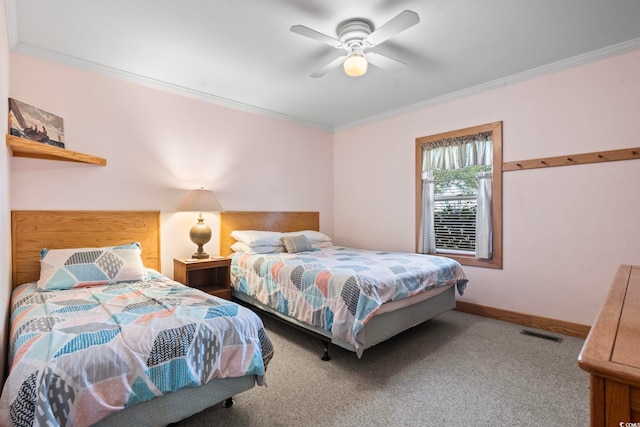 carpeted bedroom featuring ornamental molding, visible vents, ceiling fan, and baseboards