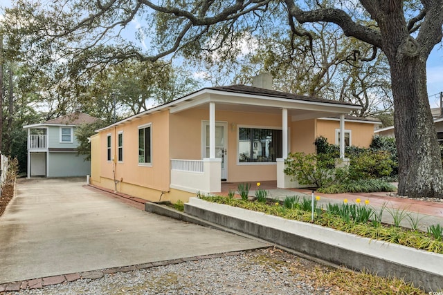 view of front of property featuring a chimney and stucco siding