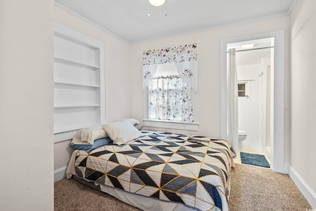 bedroom with carpet floors, ornamental molding, connected bathroom, and baseboards