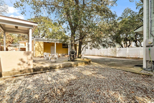 view of yard with fence and a patio