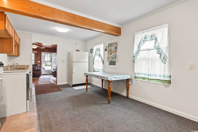 interior space featuring baseboards, carpet, beam ceiling, and crown molding