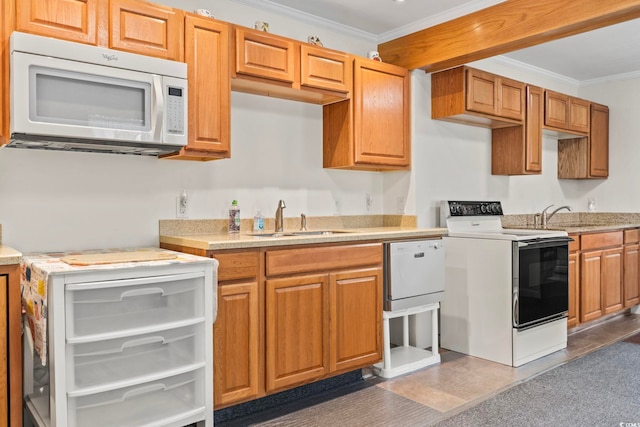 kitchen featuring ornamental molding, light countertops, white appliances, and a sink