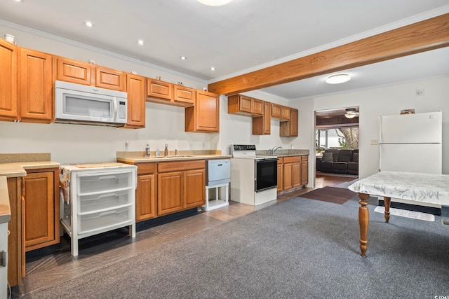 kitchen featuring ornamental molding, white appliances, light countertops, and a sink