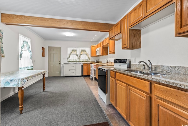 kitchen with ornamental molding, white appliances, a sink, and brown cabinets