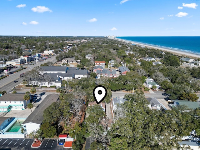 birds eye view of property featuring a water view and a beach view