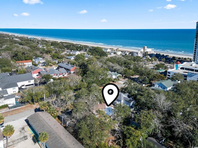 birds eye view of property featuring a water view and a beach view