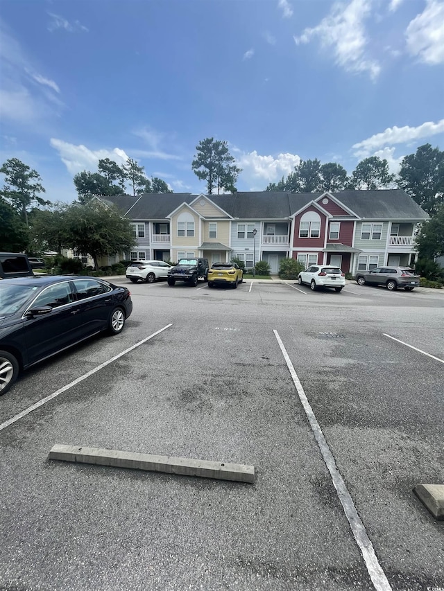 uncovered parking lot with a residential view