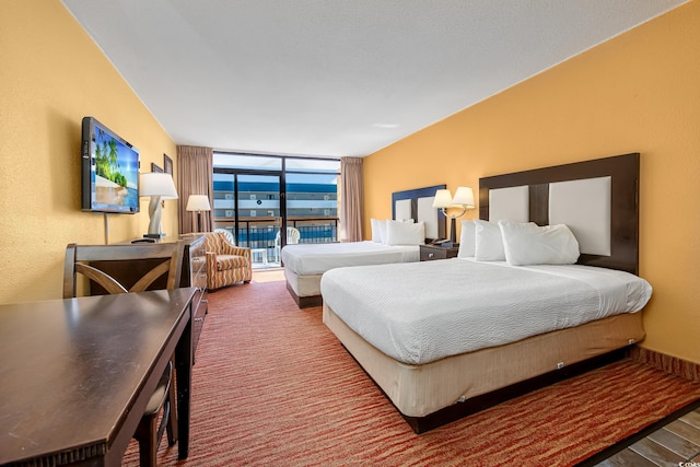 bedroom featuring carpet, access to outside, and floor to ceiling windows