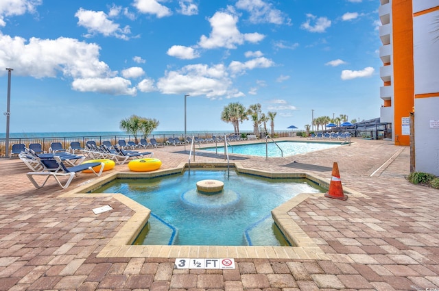 community pool featuring a patio area