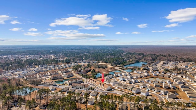 drone / aerial view featuring a residential view and a water view
