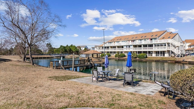 dock area featuring a water view and a yard