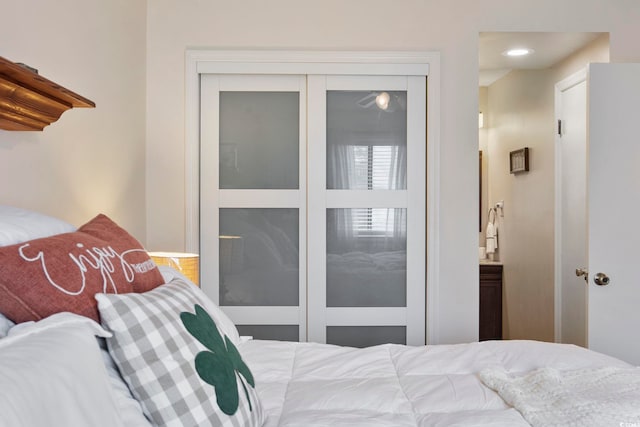 bedroom featuring ensuite bathroom, a closet, and recessed lighting