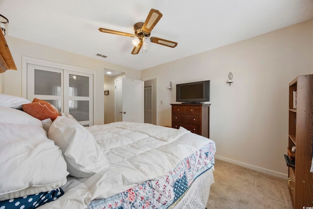 bedroom with baseboards, a ceiling fan, visible vents, and light colored carpet