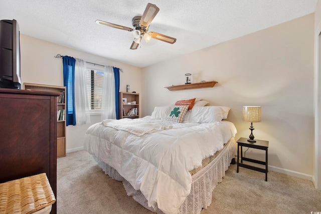 bedroom with carpet flooring, a textured ceiling, and baseboards