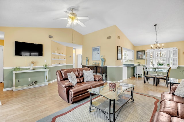 6634 Cinnamon Fern Ln, Myrtle Beach, SC 29588 - living room featuring lofted ceiling, visible vents, light wood-style flooring, and ceiling fan with notable chandelier