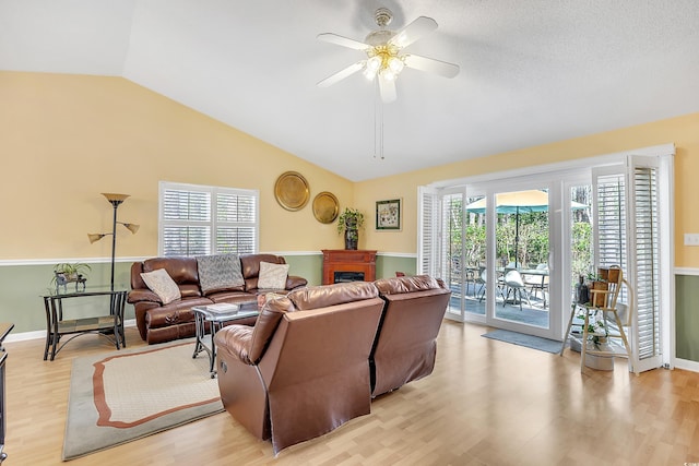 6634 Cinnamon Fern Ln, Myrtle Beach, SC 29588 - living room with a fireplace, light wood finished floors, lofted ceiling, ceiling fan, and baseboards