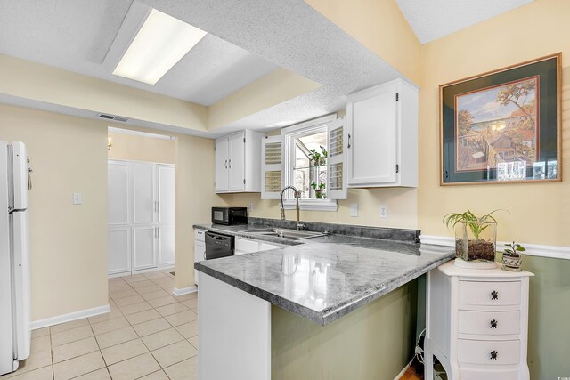 6634 Cinnamon Fern Ln, Myrtle Beach, SC 29588 - kitchen with light tile patterned floors, visible vents, white cabinets, a sink, and black appliances