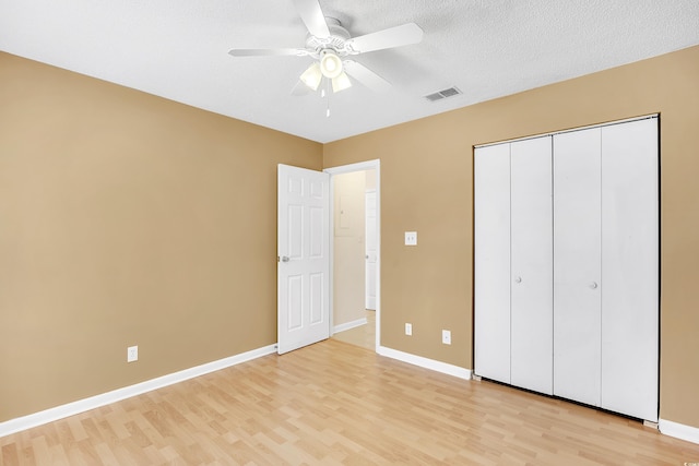 6634 Cinnamon Fern Ln, Myrtle Beach, SC 29588 - unfurnished bedroom with light wood-style floors, visible vents, a textured ceiling, and baseboards