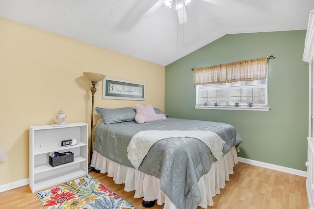 6634 Cinnamon Fern Ln, Myrtle Beach, SC 29588 - bedroom with baseboards, lofted ceiling, ceiling fan, wood finished floors, and a textured ceiling