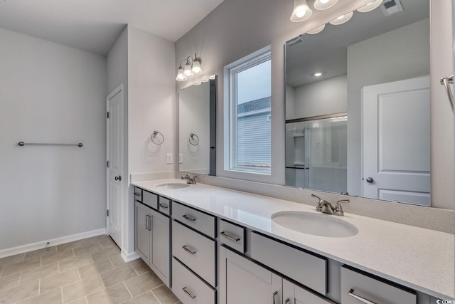 323 Dunlin Pl, Conway, SC 29526 - bathroom featuring double vanity, baseboards, and a shower with door