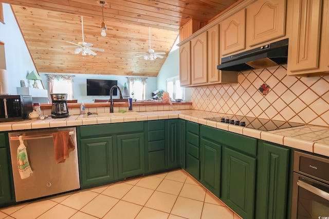 kitchen with black appliances, under cabinet range hood, a sink, tasteful backsplash, and open floor plan