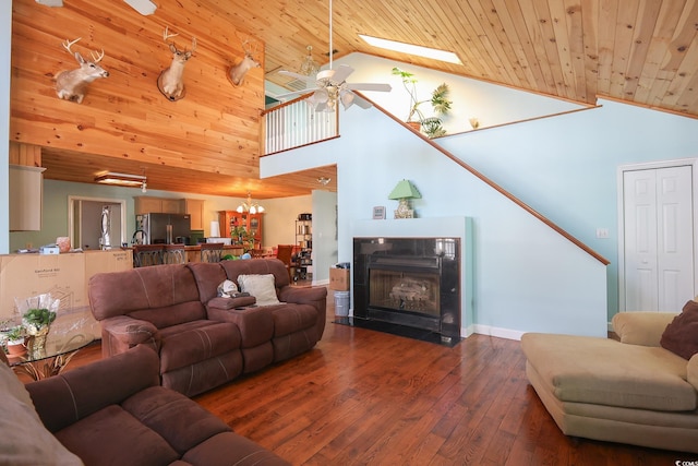 living area with a fireplace with flush hearth, lofted ceiling, wood ceiling, and dark wood-style flooring