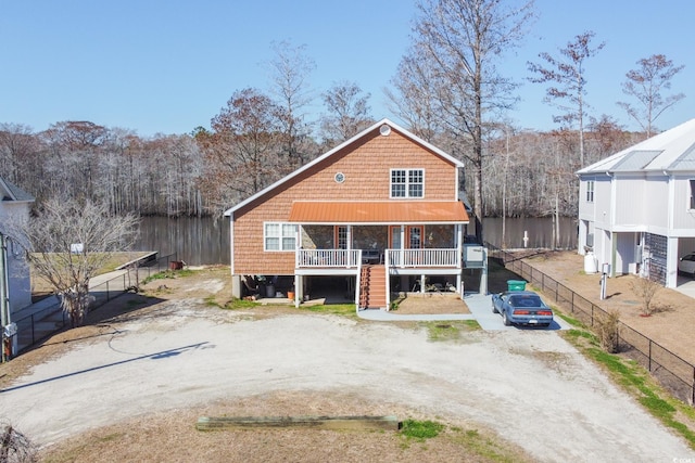 back of house with stairs, a porch, driveway, and fence