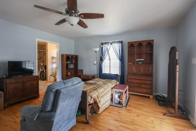 bedroom with ceiling fan, baseboards, and wood finished floors